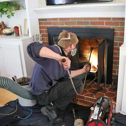 Fireplace and firebox cleaning by a Lowes Chimney Sweep technician