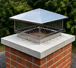 Stainless steel chimney cap installed on a brick chimney