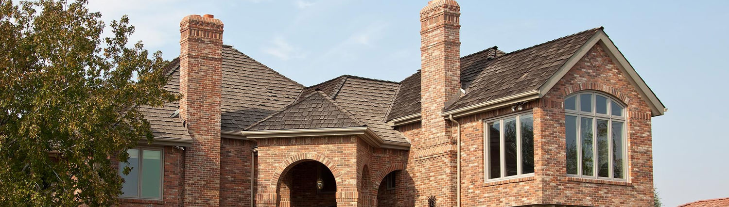Technician sealing a cracked chimney crown on a home listed for sale in Frisco, TX