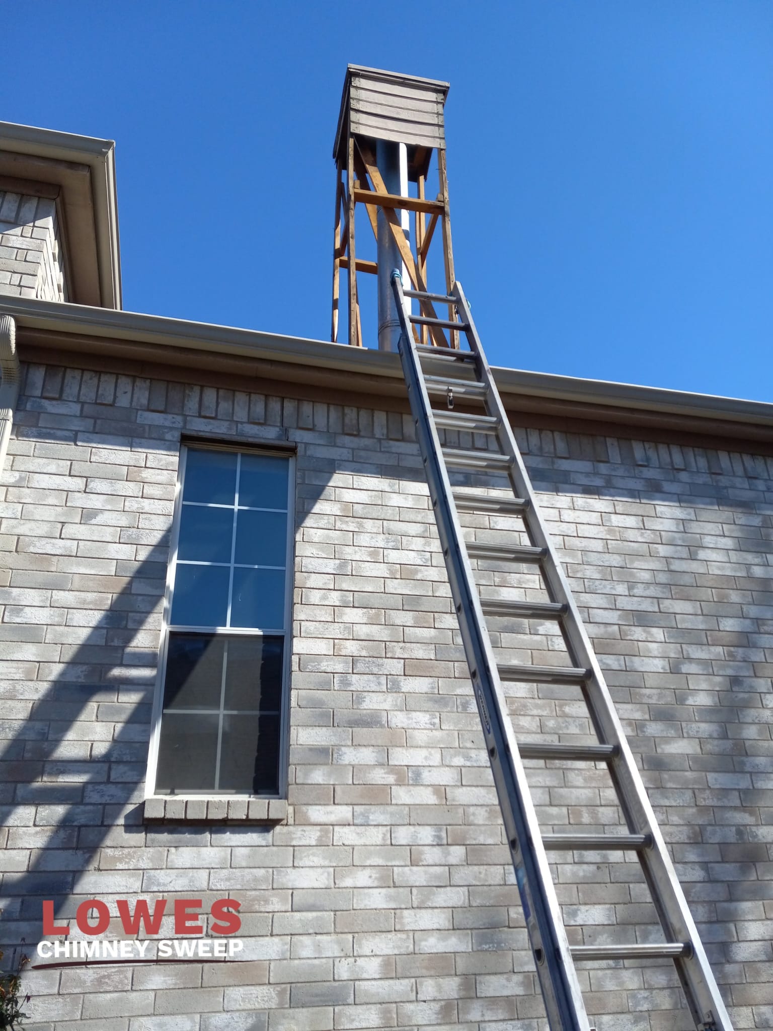 Chimney chase with damaged, weathered siding before replacement in Dallas Fort Worth