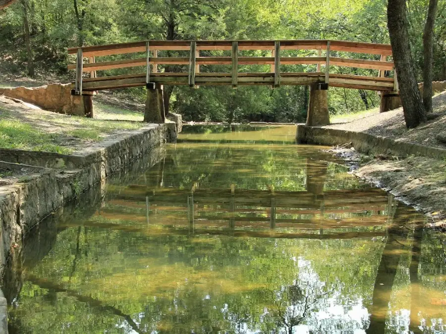 Stone channel and footbridge at Grapevine Springs Park in Coppell, Texas